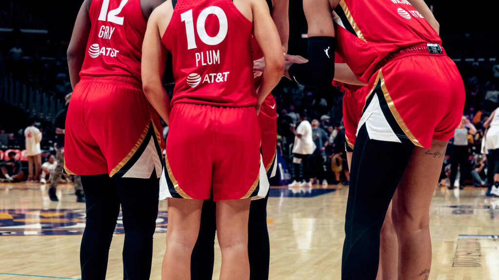 WNBA players huddle